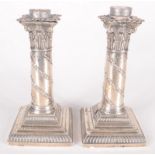 A pair of Victorian filled silver classical column candlesticks, drilled and adapted, height 17cm.
