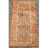 A North West Persian rug, the brown field with angular guls, flowerheads and animals,