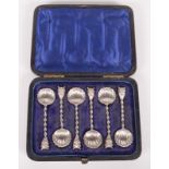 A rare set of six Victorian silver salt spoons with Mephistopheles mask finials with spiral stems