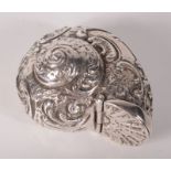 An Edwardian silver snail shape pill box with ornate rococo decoration, Chester 1903 import mark.