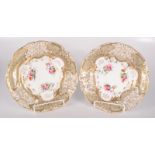 A pair of Davenport Longport porcelain plates, gilt decorated with painted floral sprays,