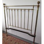 A Victorian brass bed, with turned columns and spindles, complete with cast iron side irons,