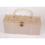 A Lucite handbag, 1950s, with grey rectangular body, floral decorated top and stiff swing handle,