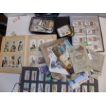 Cigarette cards in albums and loose.