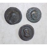 Three Roman bronze coins.