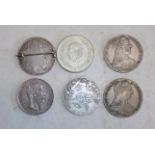 Six crown size silver coins.