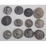 Twelve silver and other Roman coins.