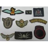 Nine cloth badges including a German airforce badge.