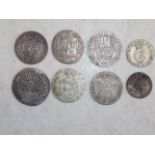 Eight World silver coins.