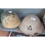 An Air Raid Warden's tin hat and a US Army hat.