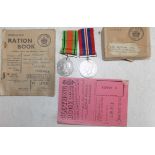WWII medal and defence in box of issue, together with unrelated ration books.