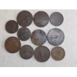 Eleven 19th century tokens.