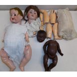 Three porcelain head dolls, each disassembled, contained in two boxes.