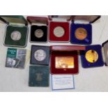 Seven miscellaneous cased items including Cornish tin 1935 abd 1951 crowns.