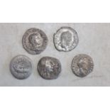 Five Roman silver coins.