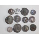 Twelve silver and other Roman coins.