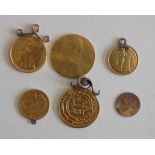 Six World gold coins each mounted or worn.