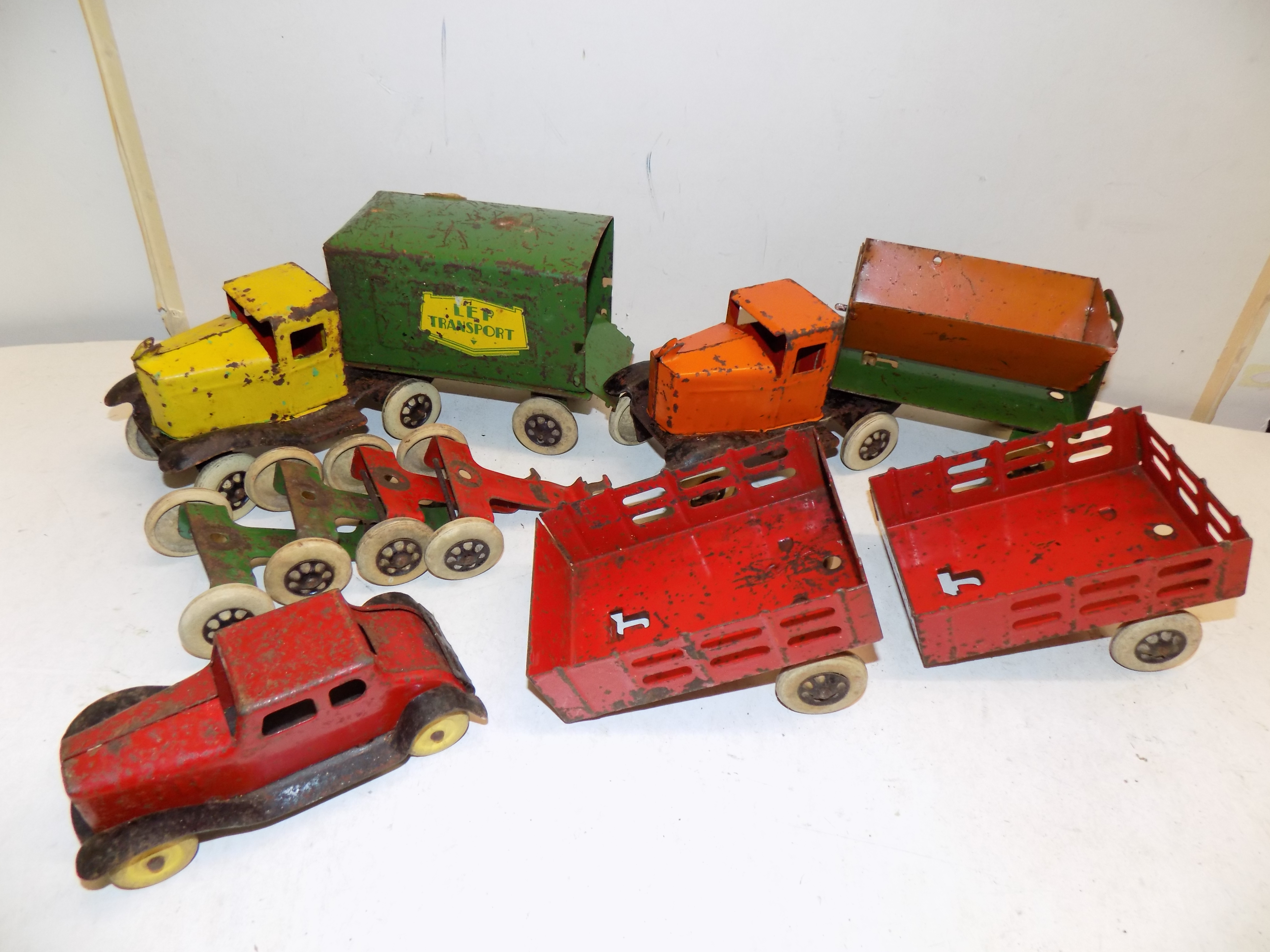 A group of heavy pressend steal toys, circa 1930's by Wyandotte, a Hoppy wagon,LEP transport wagon,