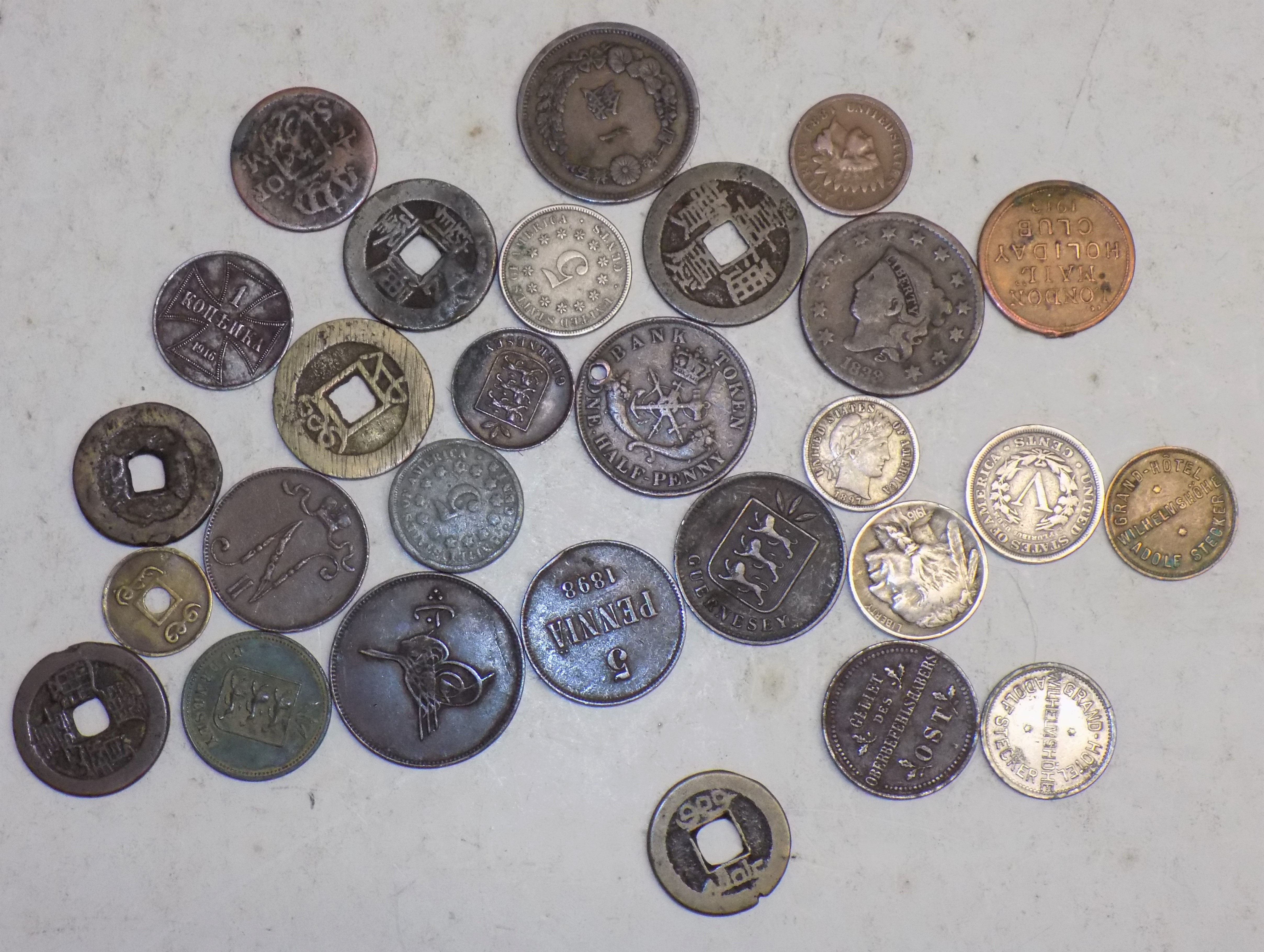 A small collection of foreign coins including "London Mail Holiday Club 1913" token,