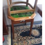An Arts and Crafts oak occasional table, the octagonal top with rows of green tiles,