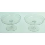 A pair of engraved glass tazzas, 19th century, height 10.5cm, diameter 18.3cm.