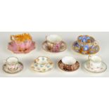 Seven miniature cups and saucers, including Coalport, Royal Crown Derby, Dresden,