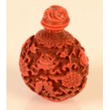 A carved red Chinese snuff bottle in 18th century style, height including stopper 7.3cm.