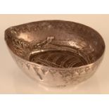 A Chinese silver coloured metal small dish, the base decorated with a stylised animal, height 2.