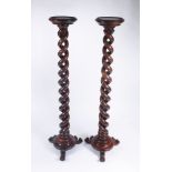 A pair of Victorian mahogany torchieres, each with a double,open, tapering,
