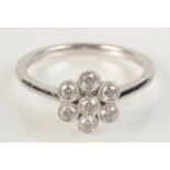 An 18ct white gold flowerhead diamond cluster ring, size M/N.