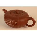 A Chinese Yixing teapot, the fluted body engraved with flowering branches and calligraphy,