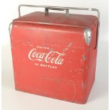A red painted metal Coca Cola ice box, the interior with a lift up metal tray, height 43cm,