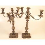 A pair of plated candelabra, each with three branches, height 49cm.