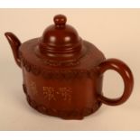 A Chinese Yixing teapot, the oval body with landscape decoration and calligraphy,