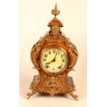 A Louise XV style French walnut and gilt metal mounted mantel clock.