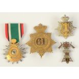 A Saudi Arabia medal Liberation of Kuwait, together with three military badges.