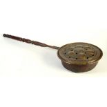 A Flemish brass warming pan, late 17th/early 18th century, with a later turned wood handle,