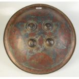 A North Indian Dhal shield in brass with coloured enamels.