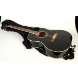 A black acoustic guitar, inscribed Music Fidelity, length 102cm.