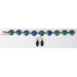A 9ct gold bracelet set with nine lapis cabochons and a pair of matching earrings.