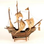 A model on a wooden galleon on stand, height 62cm, length 61cm.