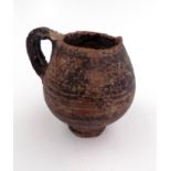 An early Mediterranean pottery cup, height 10cm, width 10cm.