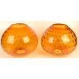 A pair of amber glass lamp shades, diameter 30cm, height 26.5cm.