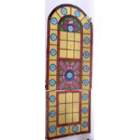 A Victorian stained glass and leaded arched window, height 134cm, width 51cm.