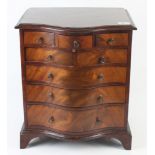 A miniature George III style mahogany serpentine chest of drawers,