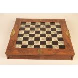 A Chinese carved wood chess set, 20th century, the white squares decorated with river scenes,