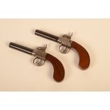 A pair of percussion muff pistols, early 19th century, with box lock and engraved with scrolls, 7.