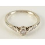 An 18ct white gold and platinum solitaire diamond ring set with a rubbed collet,