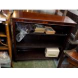 A mahogany open bookcase, 20th century, bearing an ivorine plaque inscribed 'Spillman & Co.