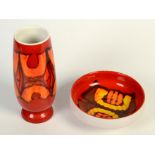 A Poole pottery vase, the red ground with geometric designs, height 22cm and a similar bowl,